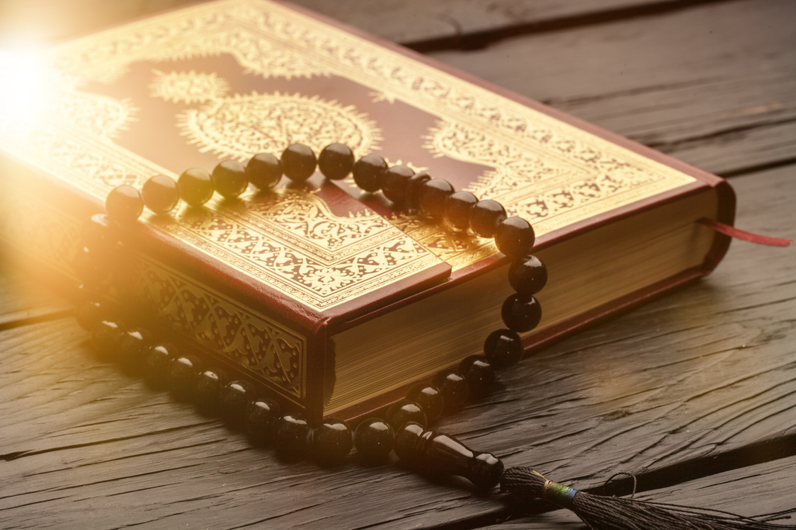 Islamic Book  with Rosary on Background